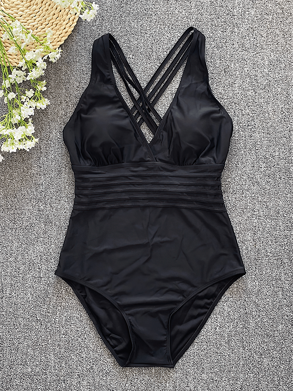 Sexy Cross Back One Piece Swimsuit for Women - SF4617 displayed on a textured surface with floral accents.