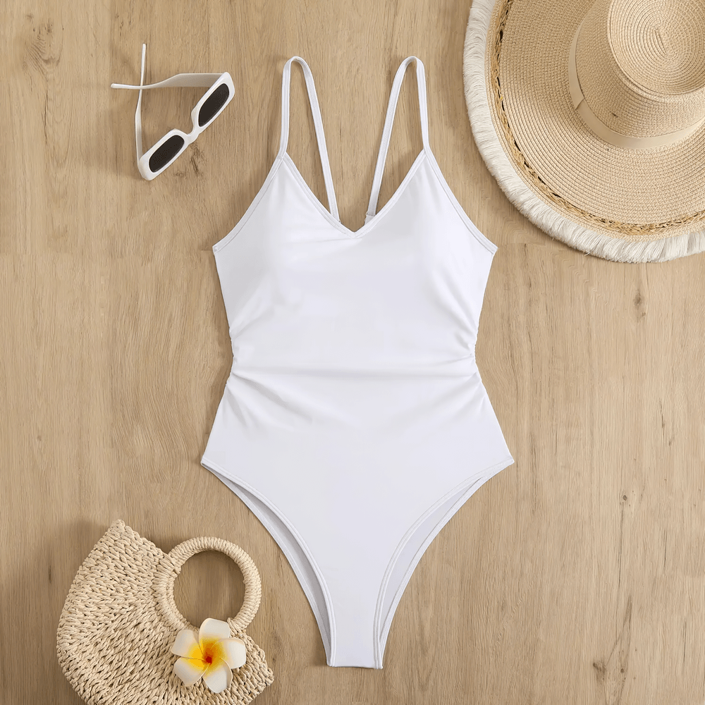 Sexy Cutout One Piece Swimsuit with Open Back - SF4546 on a wooden surface with accessories.