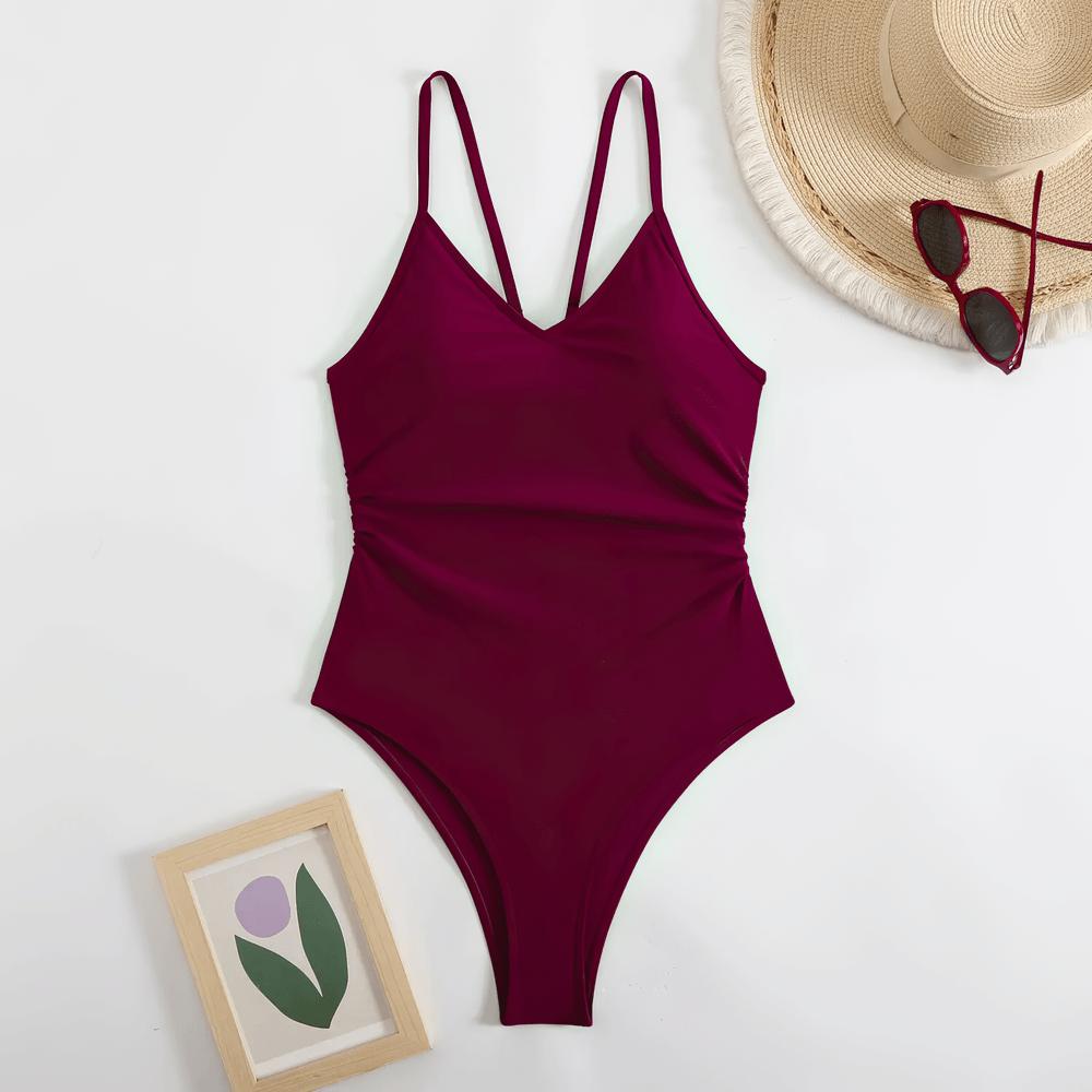 Sexy Cutout One Piece Swimsuit with Open Back - SF4546 displayed on a flat surface with accessories.