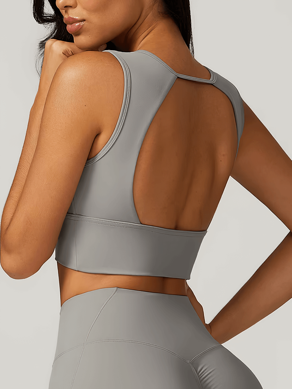 Sexy open back shockproof sports tank top for women, SF2445. Gray nylon-spandex running and gym top offering breathability and style.