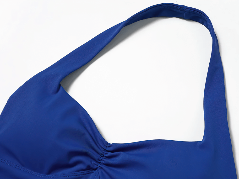 Close-up of a blue racerback sports bra with a sleek design and supportive elastic band, perfect for yoga and gym sessions.