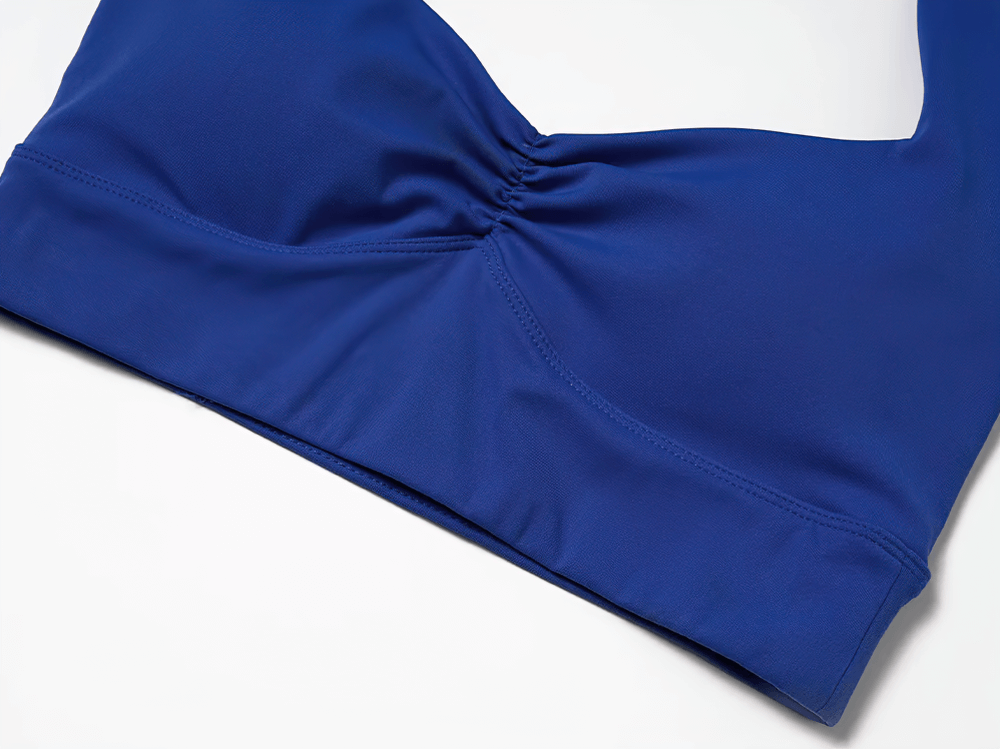 Blue racerback sports bra with padded support and sleek design for workouts and yoga.