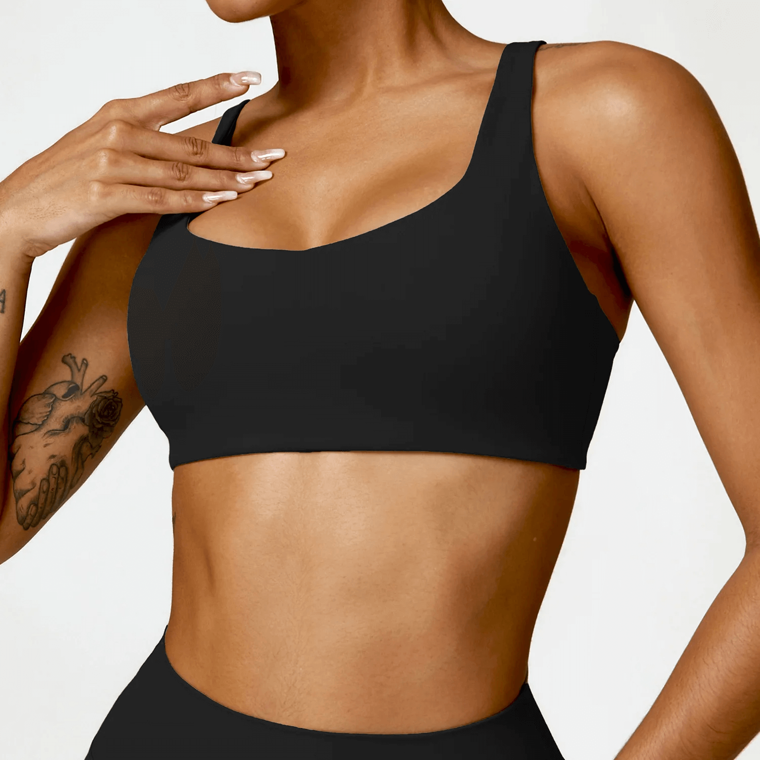 Model wearing a sleek black strappy sports bra with square neckline SF2458, designed for yoga and fitness, featuring breathable fabric.