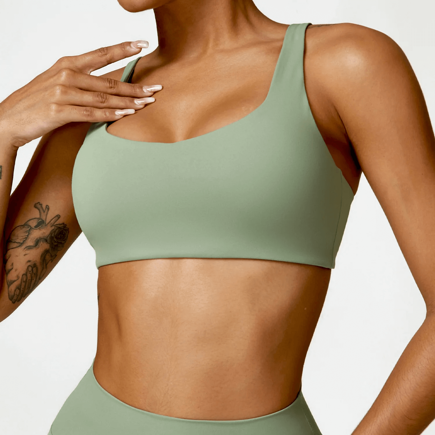 Woman wearing a stylish strappy sports bra with square neckline, perfect for yoga and fitness. SF2458 activewear fashion.