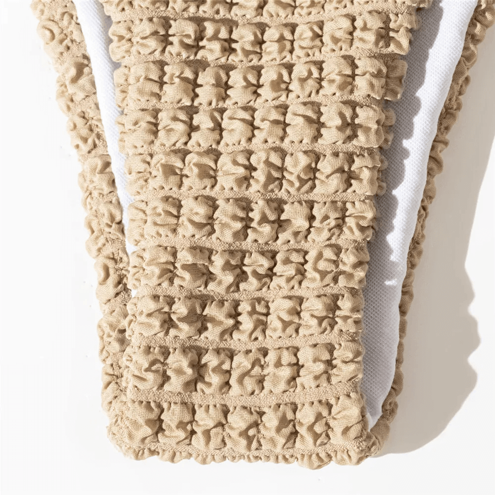 Close-up of textured bikini bottom in neutral tones, featuring a chic design for stylish beachwear.