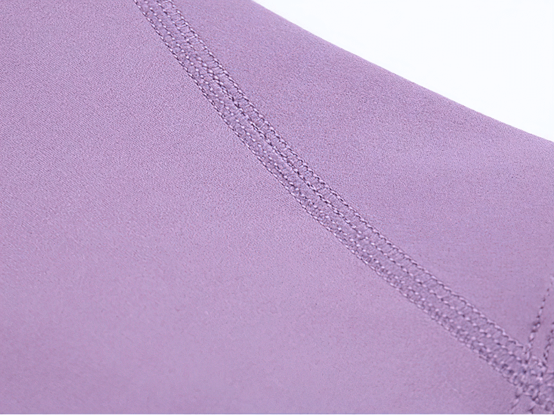 Close-up of purple fabric texture on a sexy V-neck yoga sports tank top, emphasizing the quality and stitching details.