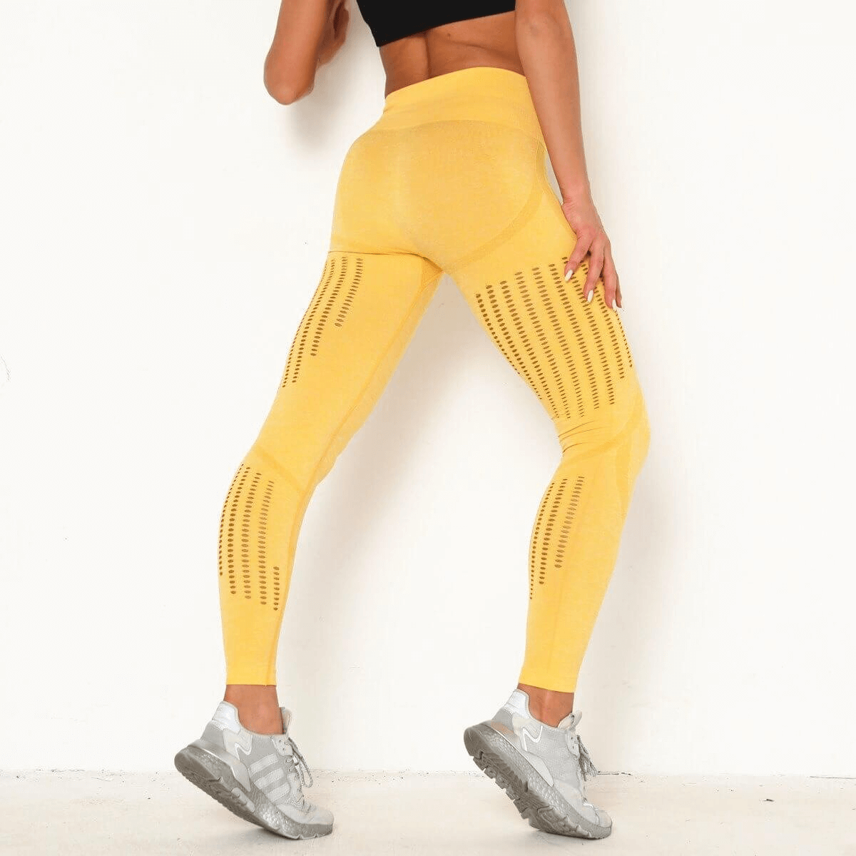 Back view of sexy women's high-waist yellow seamless leggings highlighting a booty-lifting design in breathable fabric, SF0148.