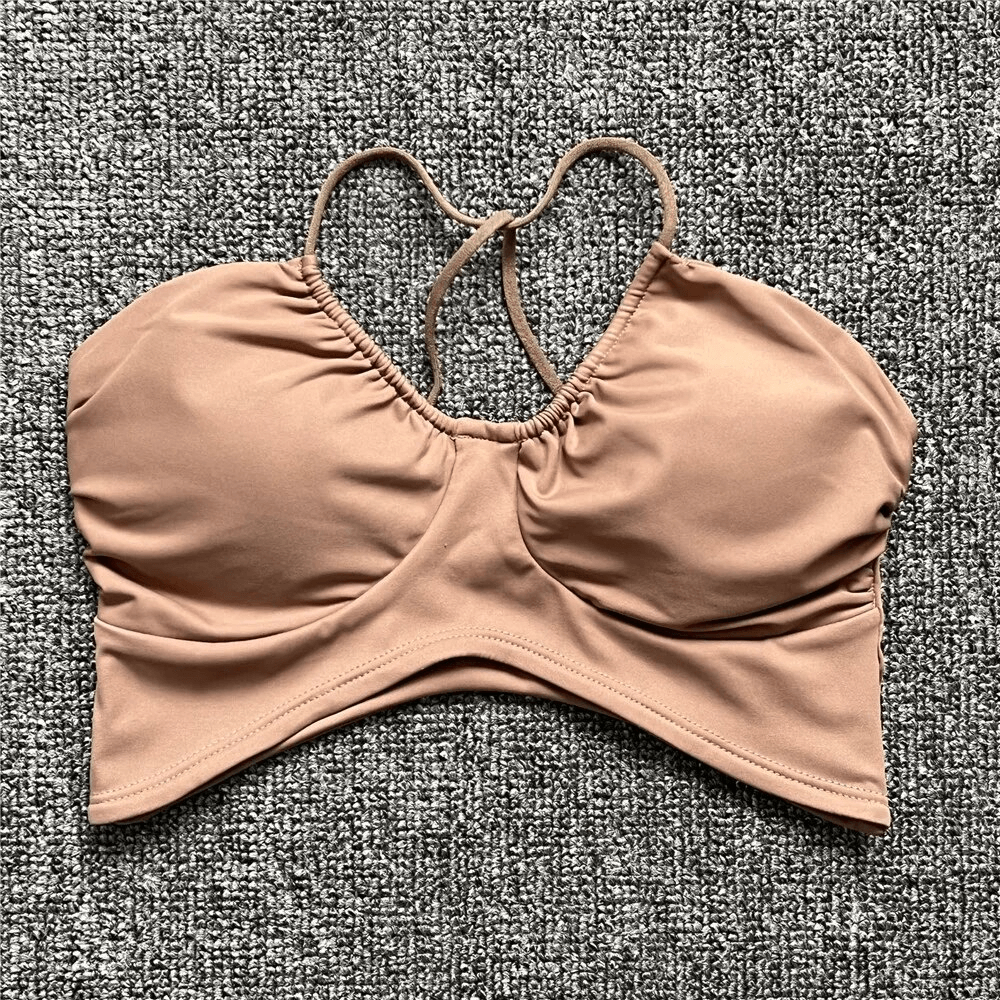 Nude sports bra with open back, deep neckline, designed for running, made of breathable polyester and spandex. Model SF1773.