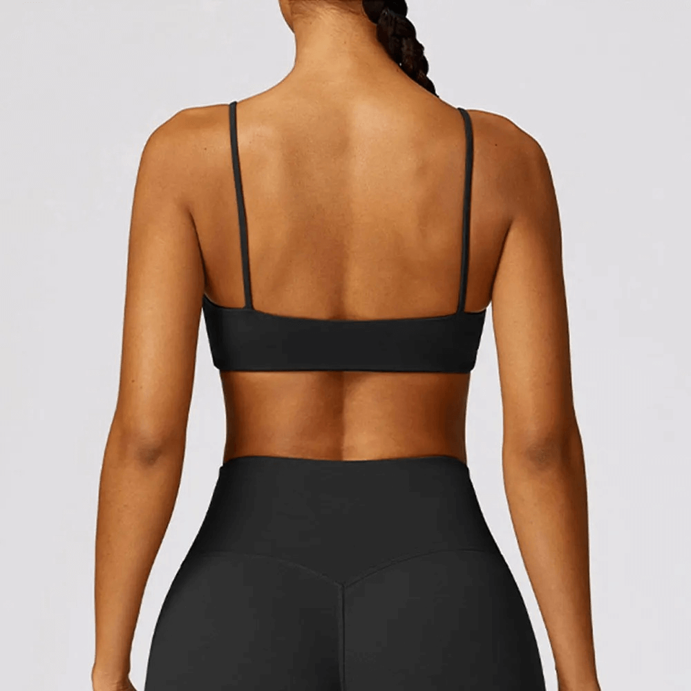 Back view of woman wearing shockproof yoga sports bra SF2457 in black, featuring breathable, quick-dry fabric for gym and fitness.