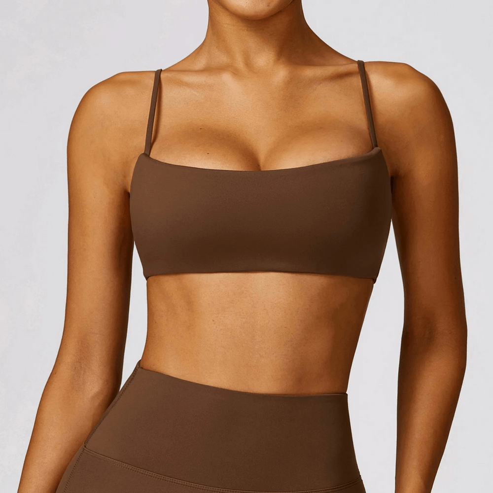 Model wearing shockproof yoga sports bra in brown, ideal for gym and fitness. Features breathable, quick-dry fabric for optimal comfort.