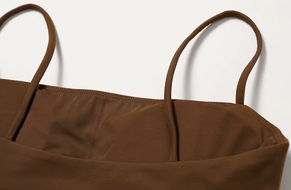 Close-up of a brown shockproof yoga sports bra with thin straps, ideal for gym, fitness, and yoga. Features breathable, quick-dry fabric.