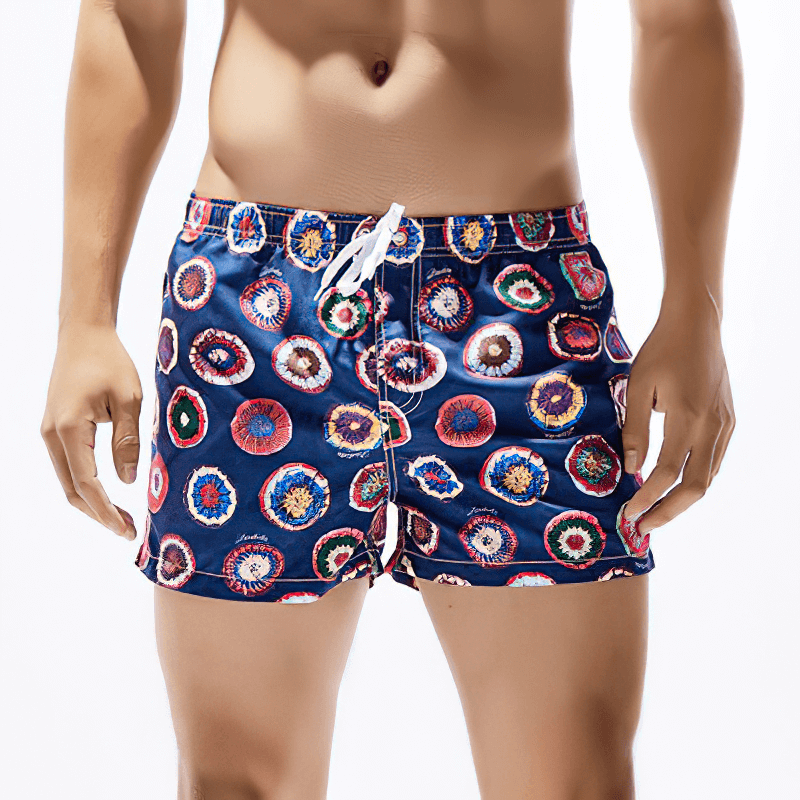 Short colorful men's boardshorts with floral pattern, perfect for the beach. Lightweight, quick-dry fabric for comfort and style.