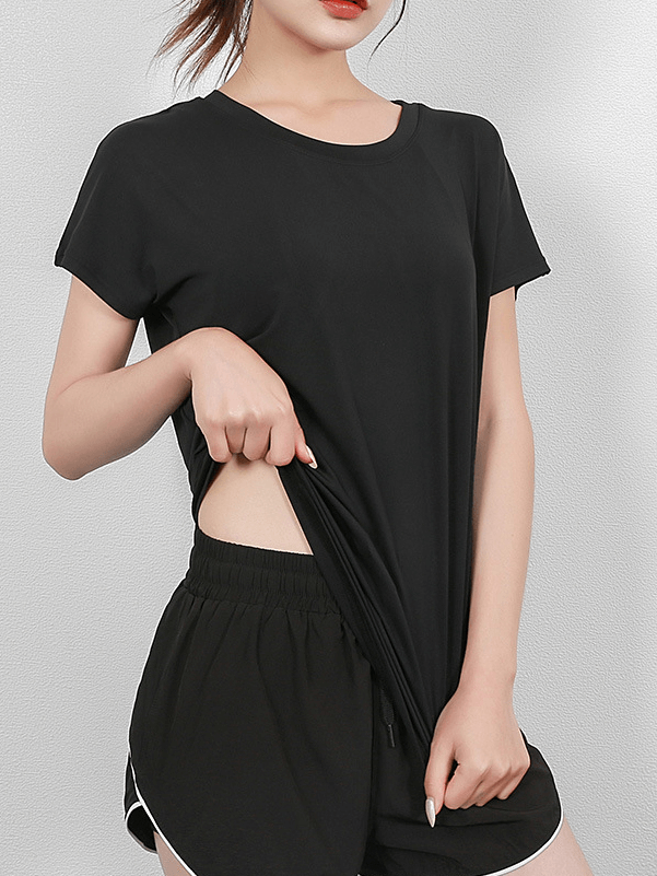 Woman wearing black short sleeves mesh yoga t-shirt with a stylish back, ideal for active wear and flexibility during yoga.