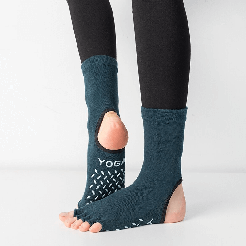 Person wearing silicone non-slip toeless Pilates socks with five finger design for yoga and dance, showing grip soles.