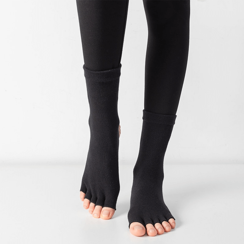Silicone non-slip toeless pilates socks with five-finger design for yoga and dance, providing optimal grip and balance during workouts.