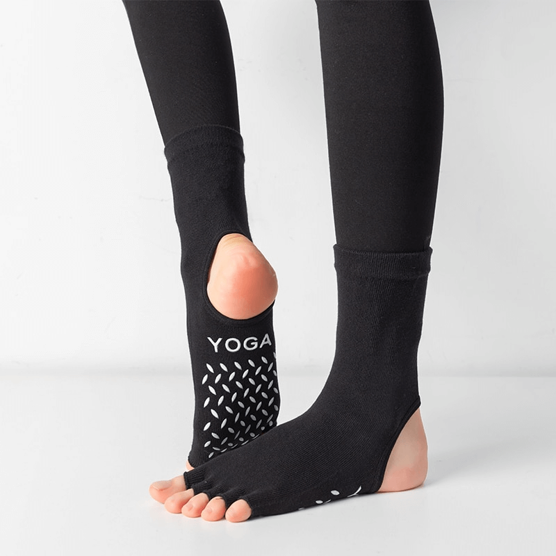 Black silicone non-slip toeless yoga socks with fun five-finger design for optimal grip and balance during pilates, yoga, and dance.