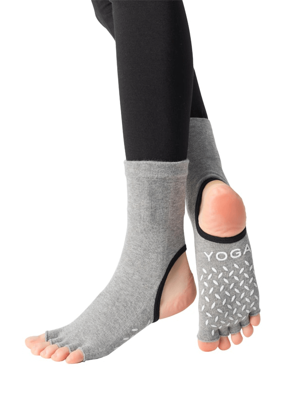 Gray silicone non-slip toeless pilates and yoga socks with five finger design for improved balance and grip during workouts.