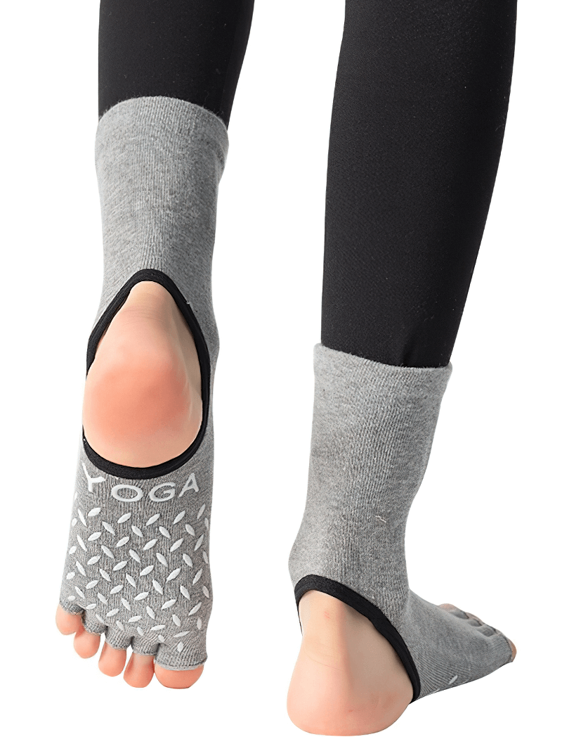 Gray silicone non-slip toeless Pilates socks with five-finger design for yoga and fitness, providing safety and elasticity.