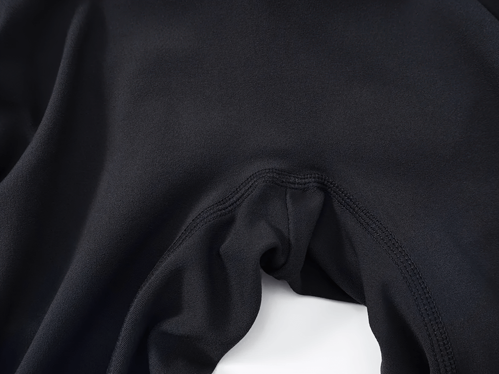 Close-up of black fabric showcasing the sleek design of the backless jumpsuit SF2367 with stitched details.