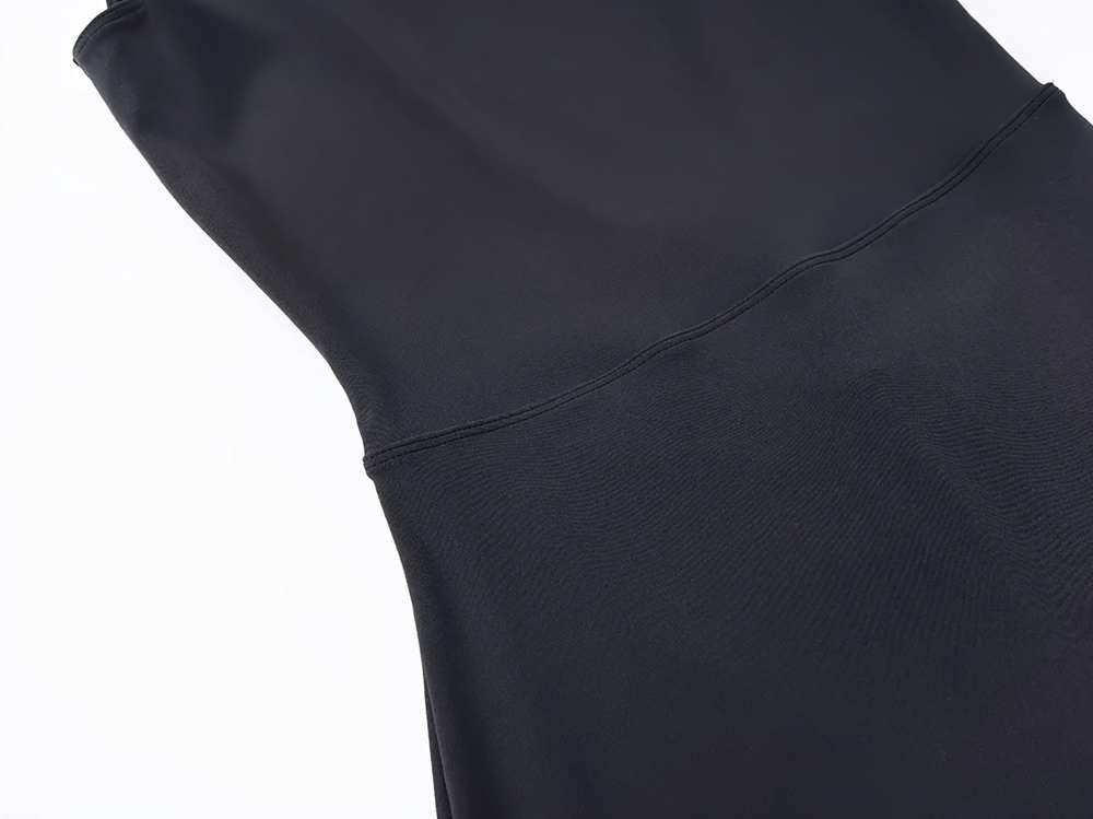 Close-up of black sleek backless jumpsuit fabric with stitching detail, showcasing the elegant design for yoga or casual wear.