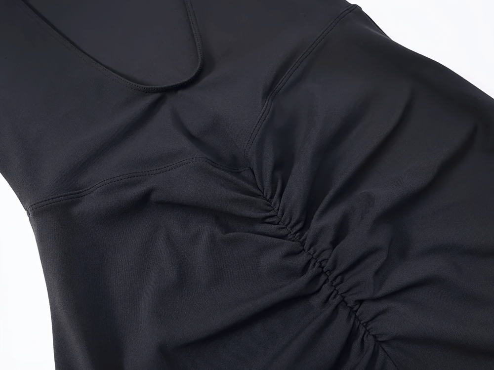 Close-up of black fabric detail on sleek backless jumpsuit with ruched front, highlighting its elegant and breathable design.