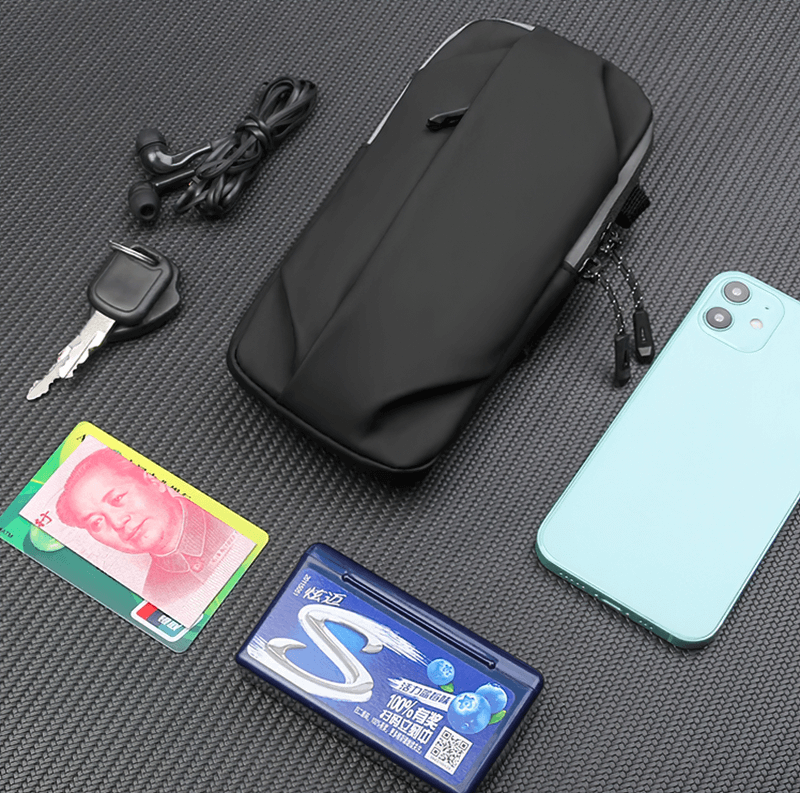 Sleek black bag SF2058 with phone, earbuds, key, currency, and gum on dark background