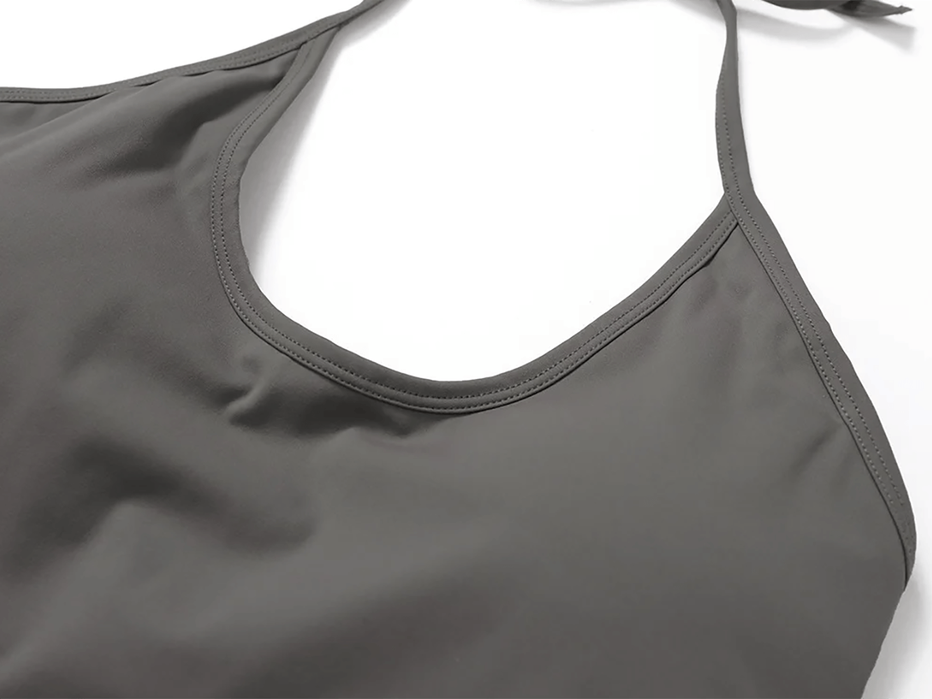 Close-up of a sleek halter neck sports tank for yoga, showcasing durable Nylon-Spandex fabric, designed for high-intensity training.