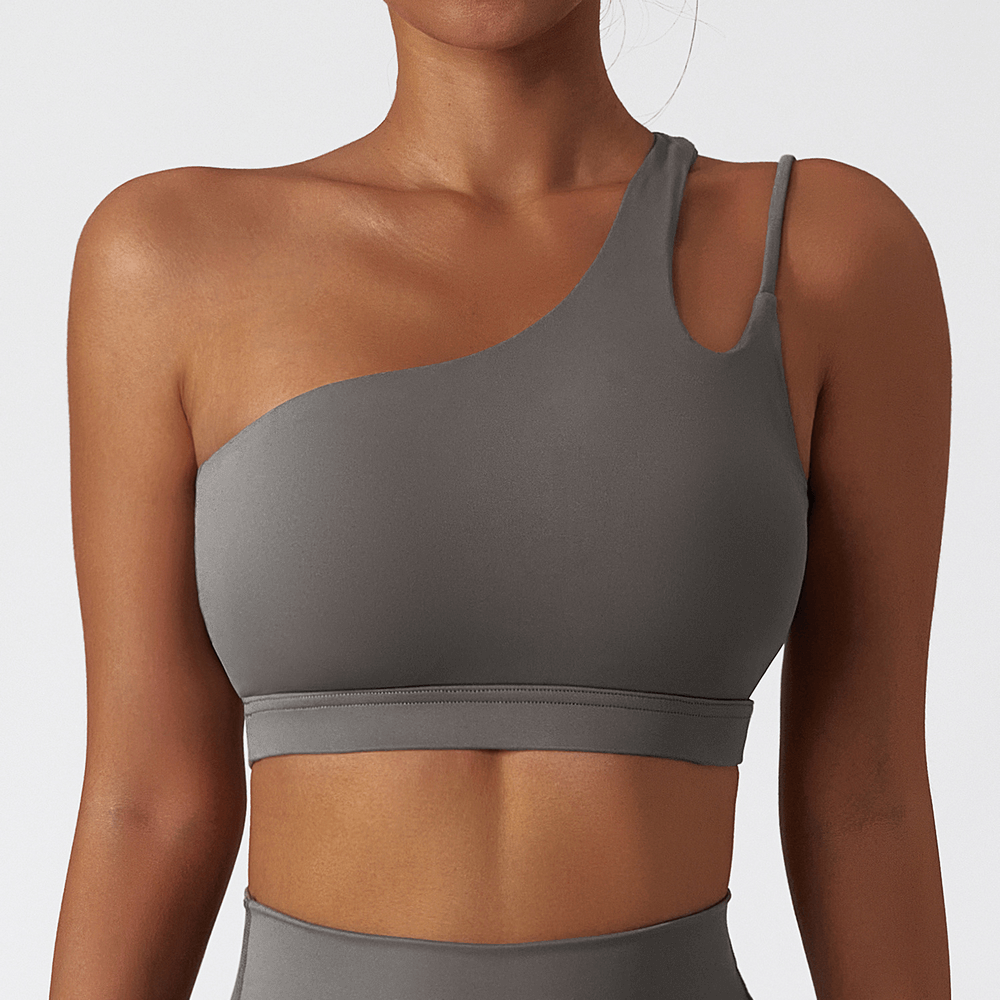 Sleek one-shoulder sports bra in gray, made from breathable nylon-spandex for active wear, perfect for running, cycling, or hiking.