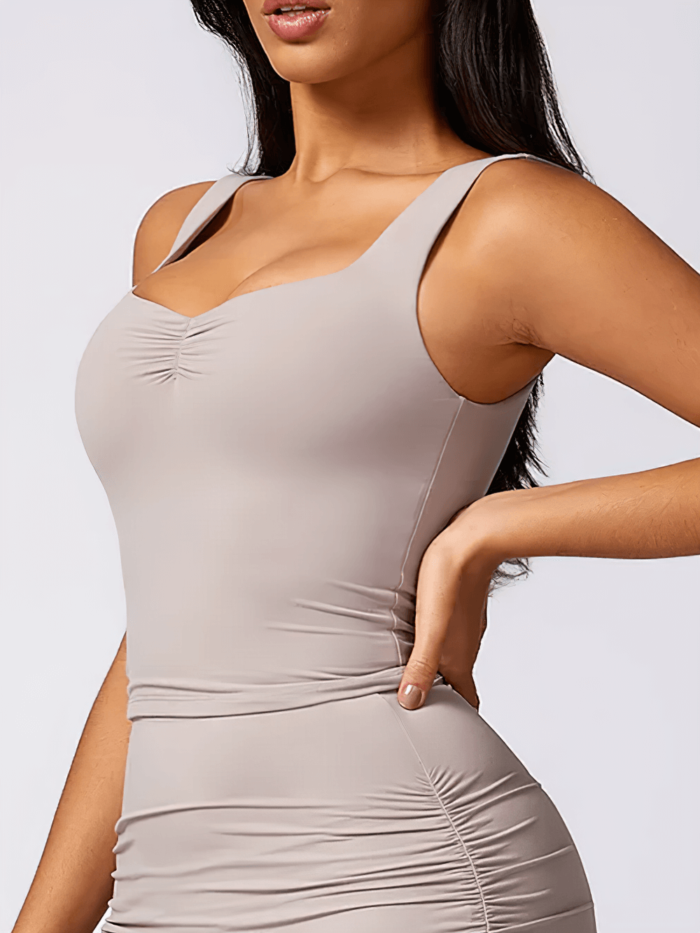 Sleek ruched square-neck tank top for women with a bodycon fit, cropped design, and wide supportive straps. Versatile style for casual or gym wear.