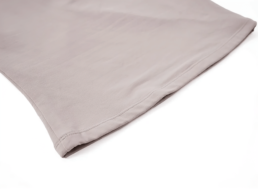 Close-up of a sleek ruched tank top in soft, stretchy fabric, showcasing the hem detail and smooth texture.