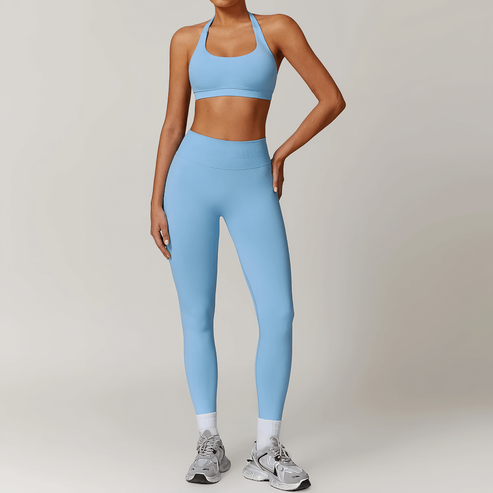 Woman wearing blue sleek sculpt leggings and halter bra activewear set, perfect for workouts, yoga, and casual outings.