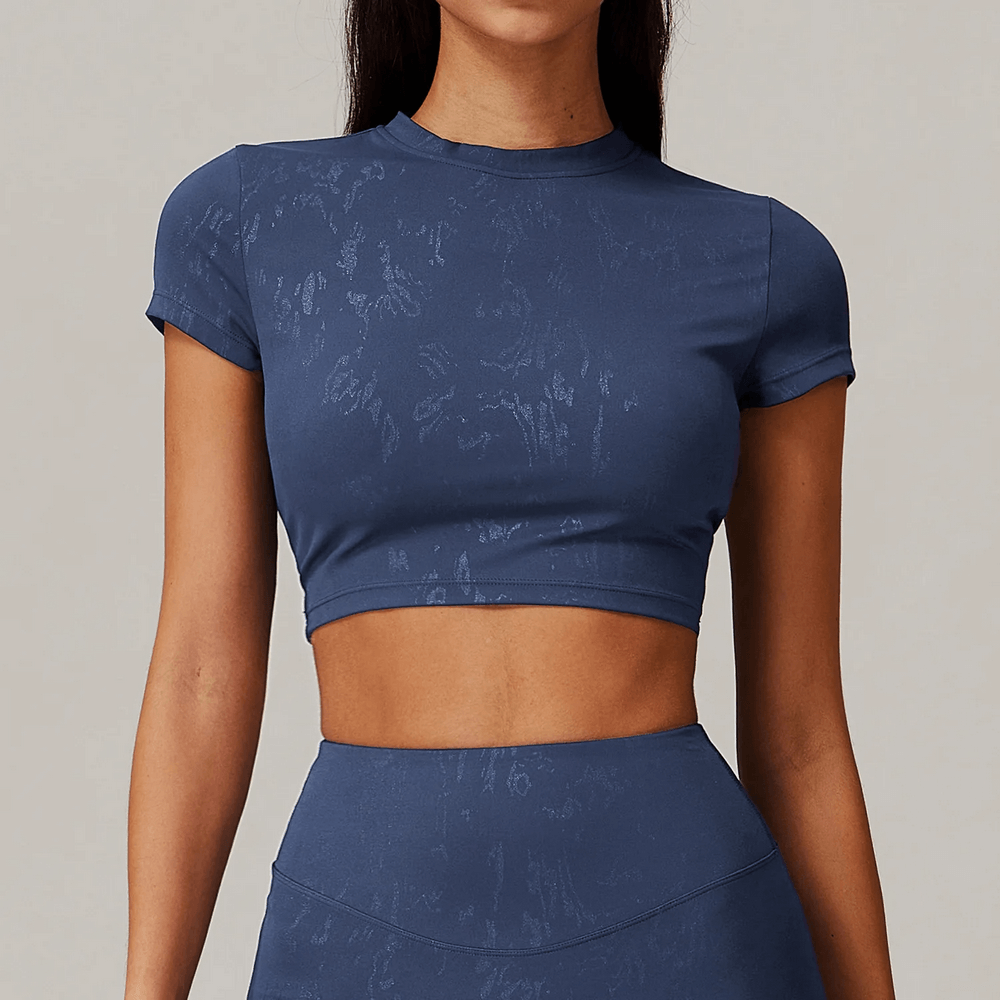 Sleek short-sleeve cropped active top for women, perfect for gym sessions, yoga, and casual wear, shown in blue.