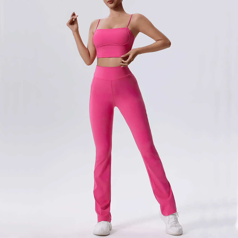 Woman in sleek pink fitness set with high-waist leggings and sleeveless top, designed for yoga and gym workouts, eco-friendly and breathable.