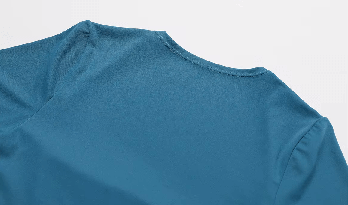 Close-up of the back of a blue athletic one-piece suit, highlighting the breathable nylon and spandex fabric.