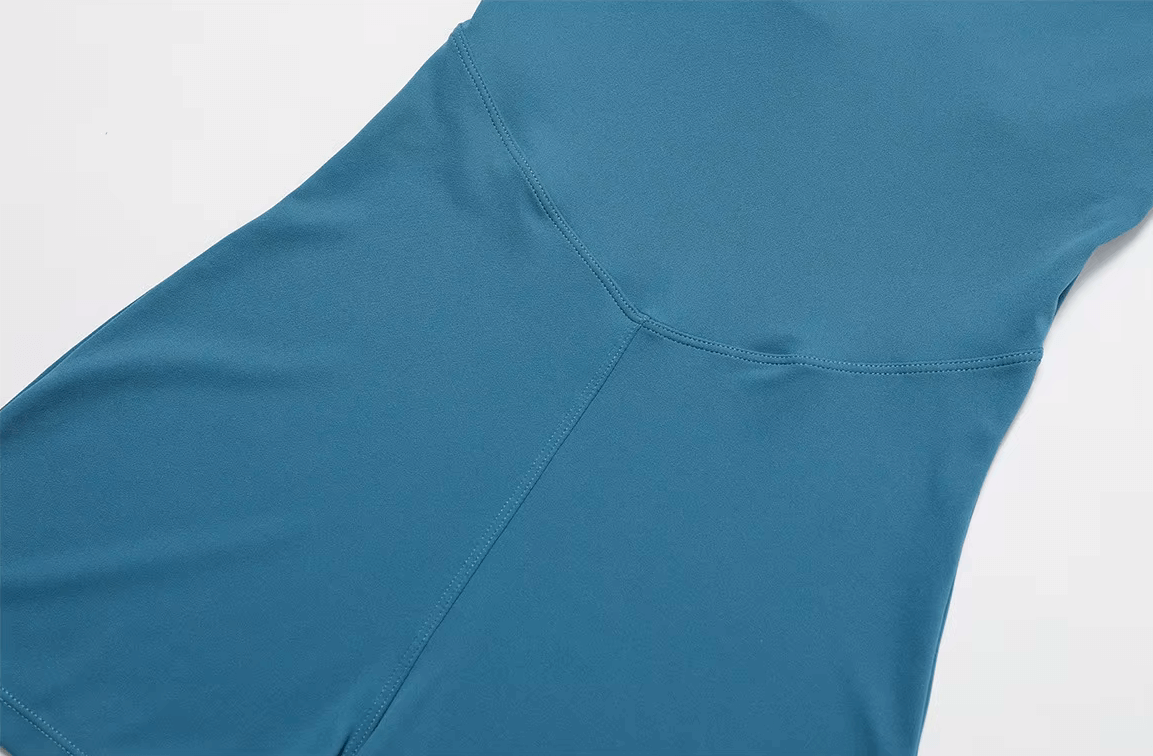 Close-up of blue women's short-sleeve athletic one-piece suit, perfect for yoga or running, made from breathable nylon and spandex.