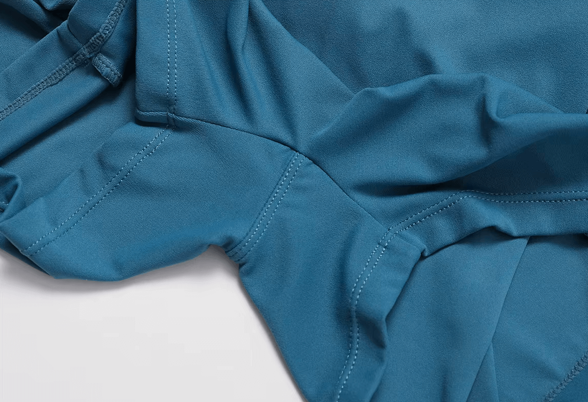 Close-up of blue women's short-sleeve athletic one-piece suit fabric, showcasing breathable and quick-drying material