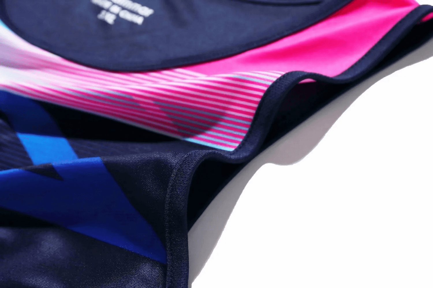 Close-up of colorful women's athletic tank and shorts set, showcasing sleek design and breathable fabric for active performance.