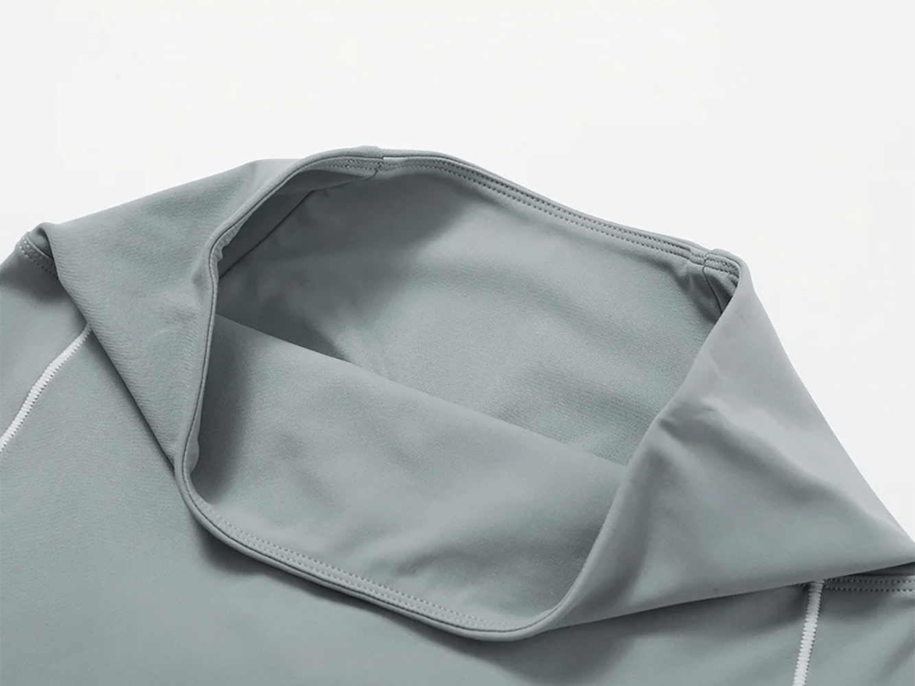 Close-up of a sleek yoga top from women's athletic set, featuring durable quick-dry fabric. Ideal for fitness routines and versatile sports wear.