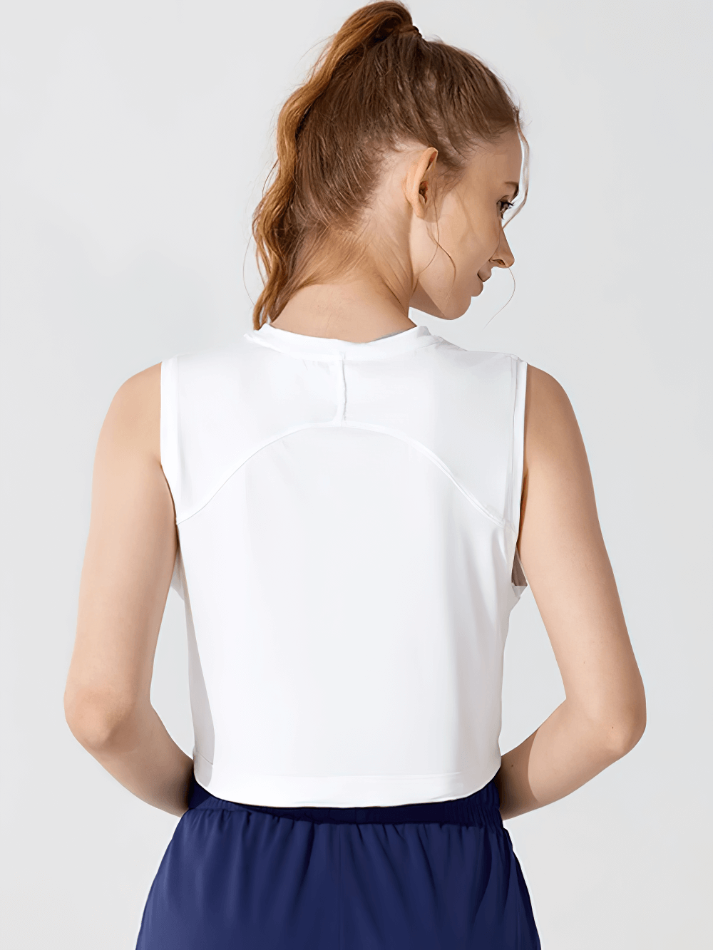 White workout tank top with O-neck and drawstring shown from the back, perfect for gym and yoga, featuring breathable, quick-drying fabric.