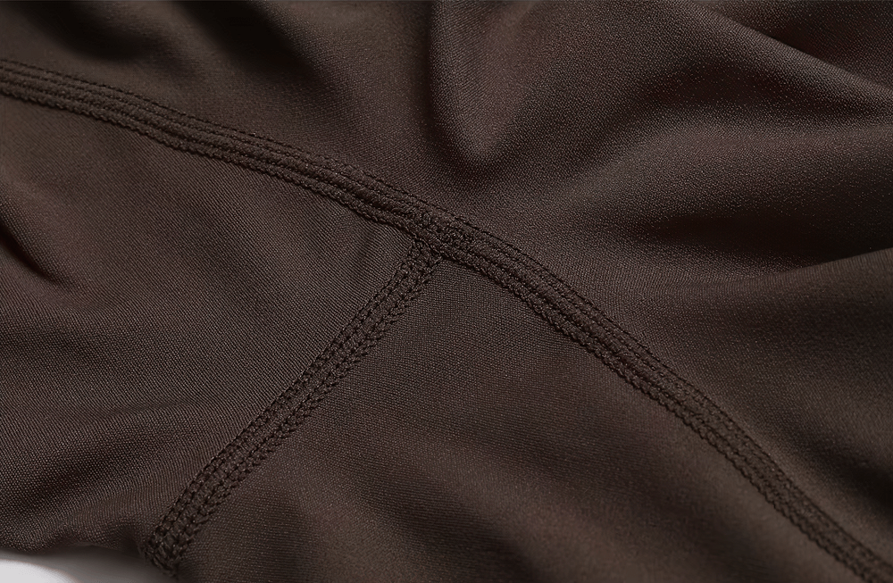 Close-up of fabric texture on a durable nylon and spandex yoga jumpsuit, showing stitching and flexible material ideal for activewear.