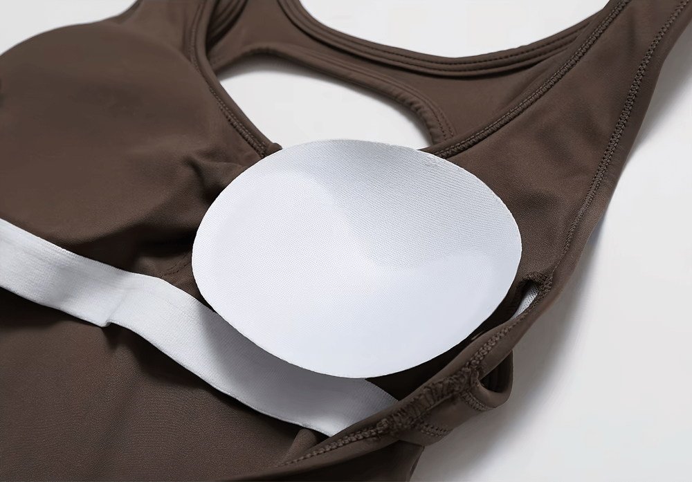 Close-up of brown yoga jumpsuit with removable padding, showcasing comfort and design details for fitness enthusiasts.