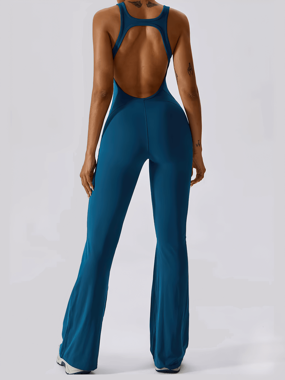 Sleeveless backless flared yoga jumpsuit for women in blue, ideal for dance and fitness activities.