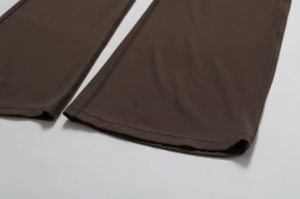 Close-up of flared pants on a brown yoga jumpsuit for women, showcasing breathable fabric ideal for dance and fitness.