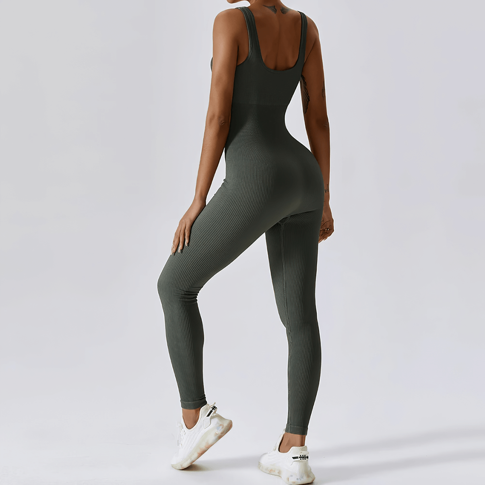 Woman wearing sleeveless seamless one-piece yoga suit, charcoal color, ideal for fitness, running, or yoga.