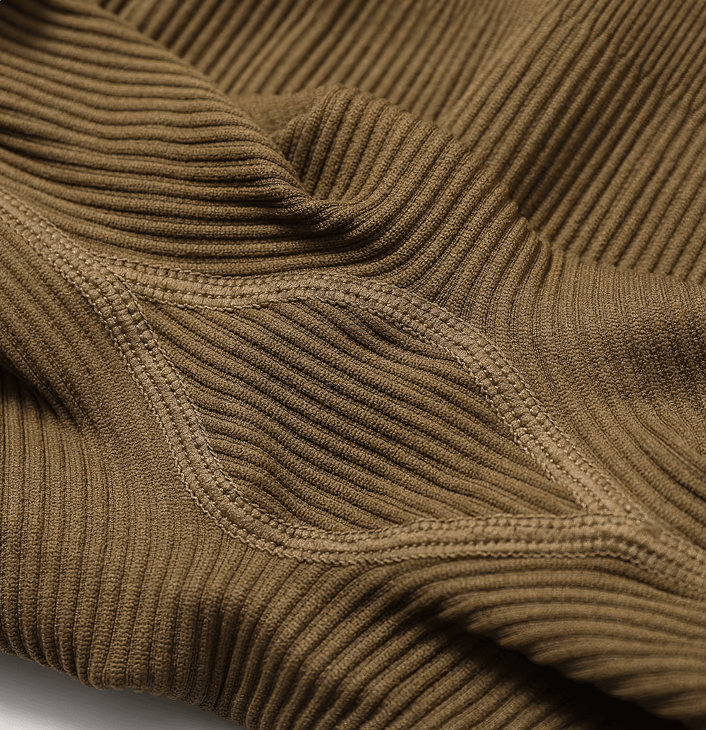 Close-up of brown ribbed seamless fabric showcasing stitching detail on yoga suit.