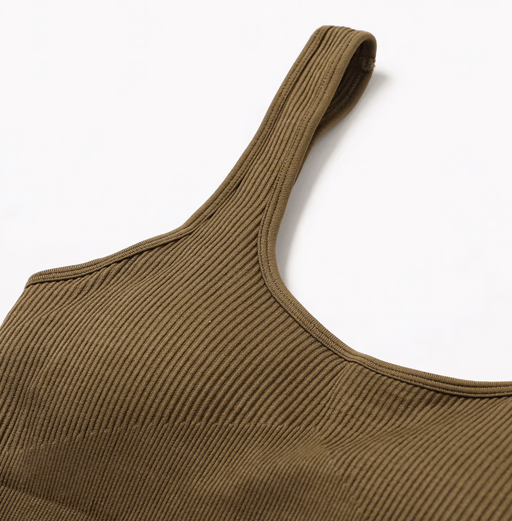 Sleeveless seamless one-piece yoga suit in brown, close-up on breathable quick-dry fabric, ideal for women’s active sportswear.