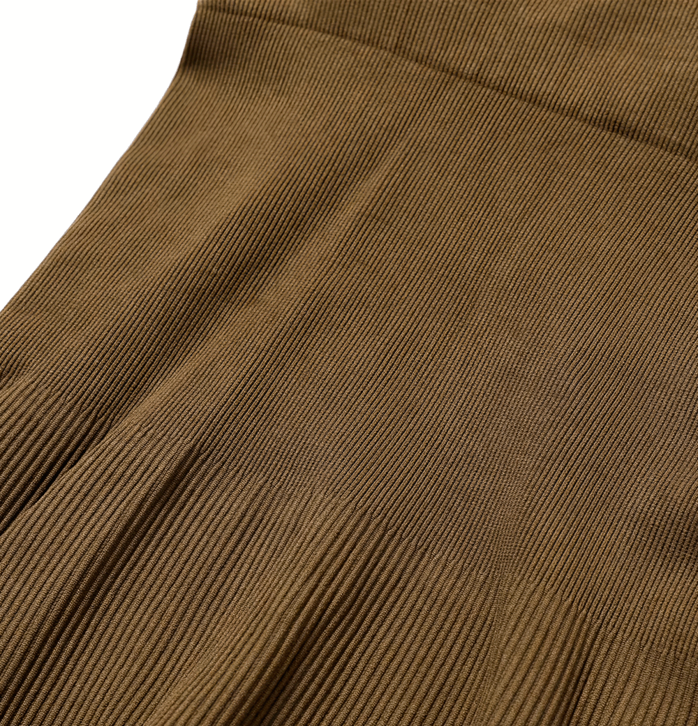 Close-up of brown ribbed texture on a women's seamless yoga suit, crafted from durable, breathable fabric with quick-dry technology.