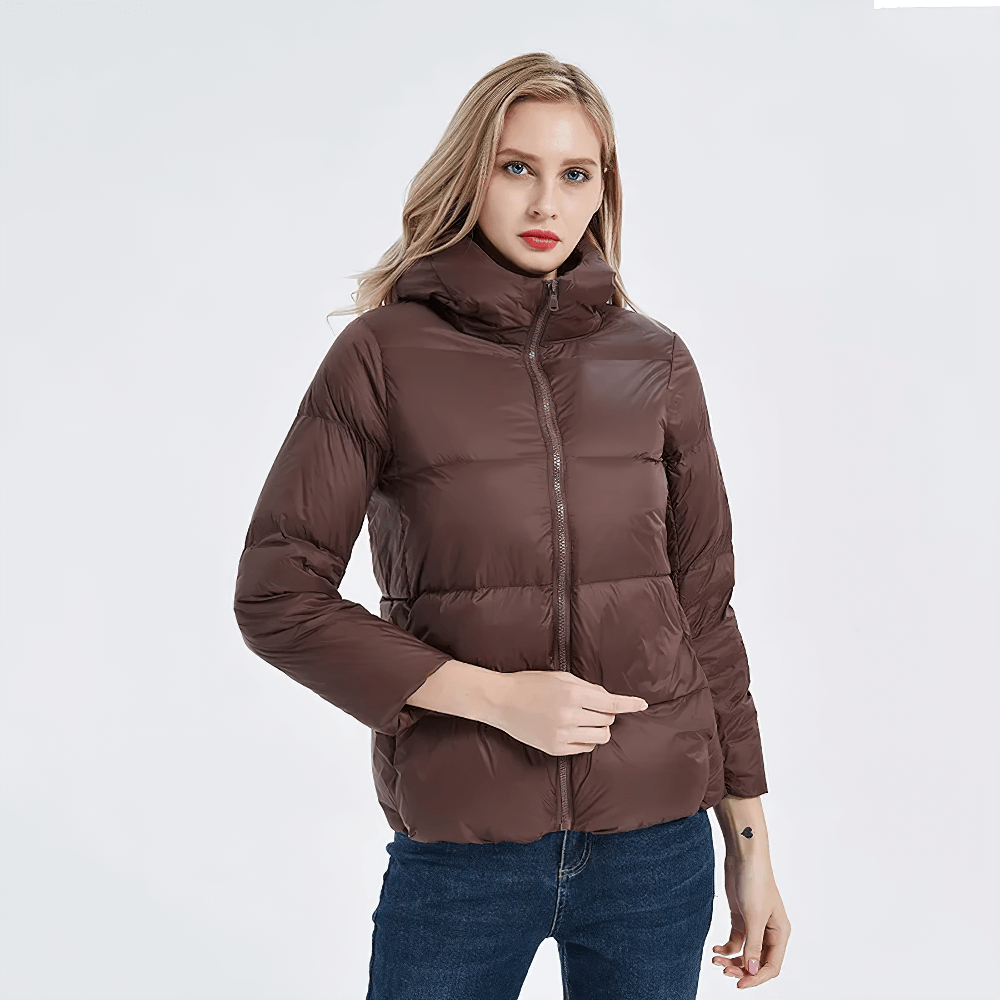 Woman wearing a brown slim-fit duck down jacket with hood and pockets, perfect for chilly days.