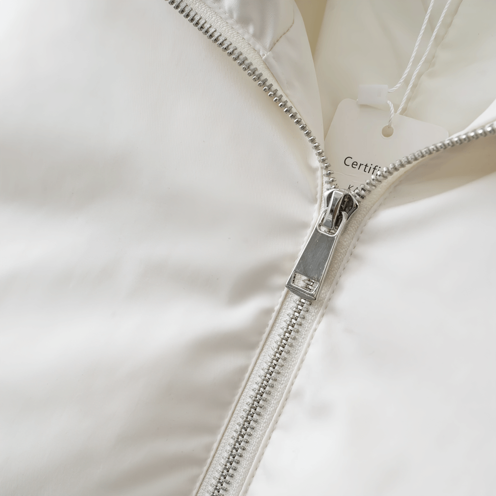 Close-up of white slim fit jacket zipper, showcasing broadcloth fabric and durable design. Perfect winter style statement.