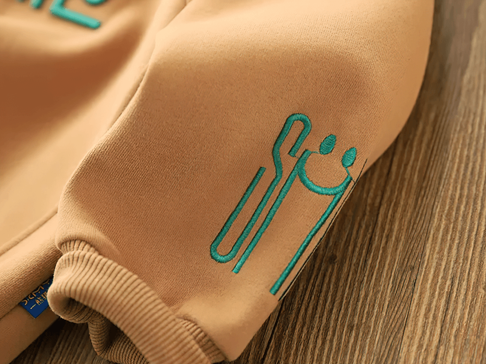 Beige children's sweatshirt sleeve with green SMILE graphic and elastic cuff, featuring stylish and cozy fabric design, SKU SF3105.